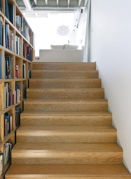 monkman-residence-detail-stairs Natural grain wood stairs by bookshelves