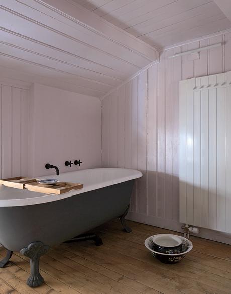 Swiss family getaway small space renovation with pink bathroom and enamelware tub