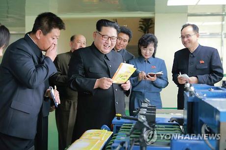 Kim Jong Un Visits Mindulle Notebook Factory Kim Jong Un inspects a notebook and other products of the Mindulle Notebook Factory (Photo: KCNA-Yonhap).