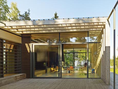How a 1,000-Year-Old Technique Made This Pavilion Swedish guesthouse with oversized glass doors to the living room