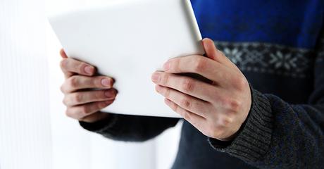 Closeup portrait of a male hands holding tablet computer