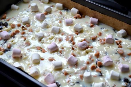 Magic bars - biscuit base, topped with walnuts, chocolate chunks, white chocolate chips, butterscotch bits, desiccated coconut, condensed milk and mini marshmallows.