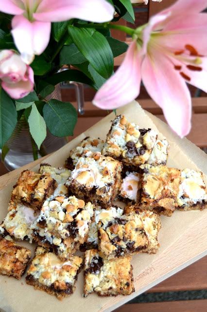 Magic bars - biscuit base, topped with walnuts, chocolate chunks, white chocolate chips, butterscotch bits, desiccated coconut, condensed milk and mini marshmallows.
