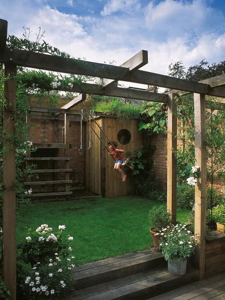 A family friendly backyard! Simon Fraser designed this unique outdoor space featuring an arbor incorporating a child's play space.:
