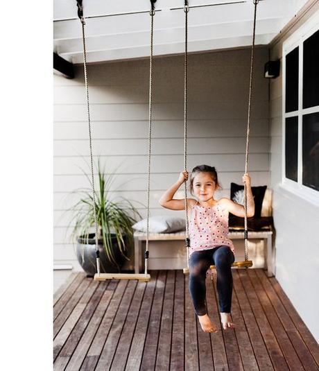 A family friendly backyard! Swings on front porch. Great idea, kids can get out and play even when it's raining.:
