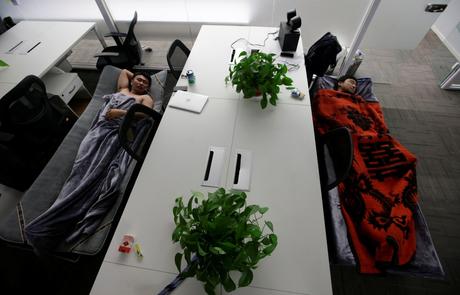 Some employees at RenRen Credit Management Co. sleep on provided camp beds in their office.
