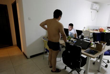 Some offices are run out of apartments, such as N-Wei (Beijing) Technology Co. Ltd. Here, a programmer chats with his colleague before he heads off to bed.