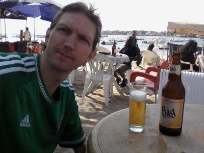Friday’s Featured Food: Barbecued Fish and Flag Beer on N’Gor Beach, Dakar, Senegal Friday's Featured Food: Barbecued Fish and Flag Beer on N'Gor Beach, Dakar, Senegal