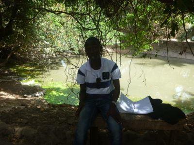 Stroking Crocodiles at Kachikally Pool, Bakau, The Gambia Moses Bajo - crocodile expert, The Gambia