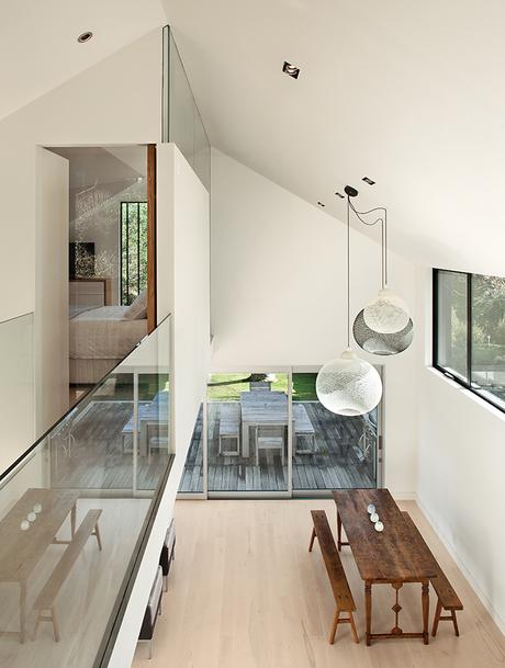 This Former Garage Is Clutter Free New Zealand home has double height ceiling with Moooi pendant lamps above the dining area