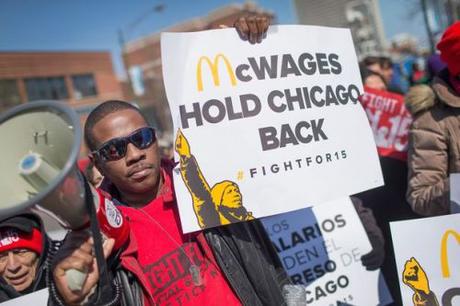 Minimum wage hikes hasten replacement of human workers by robots Demonstrators for minimum-wage increase