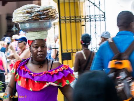 This beautiful Cartagenian woman skillfully carries her wares effortlessly on her head.