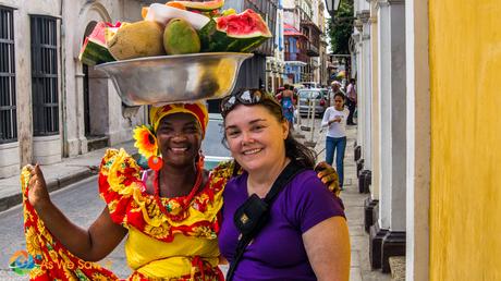 Two very warm smiles as colorful characters are ready to enjoy some fresh fruit in the UNESCO walled city of Cartagena.