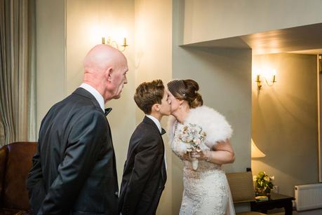 bride kissing her son before wedding