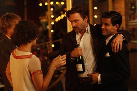 Ernest Hemingway in Midnight in Paris A production image from Midnight in Paris clearly shows Hemingway's striped shirt and vintage Moët bottle.