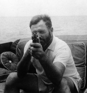 Ernest Hemingway in Midnight in Paris Keep in mind that Hemingway was the type of guy who would go fishing with a Thompson submachine gun, as seen here in 1935.