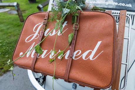 Rustic Wedding with Adam + Jaclyn a suitcase with just married written on it