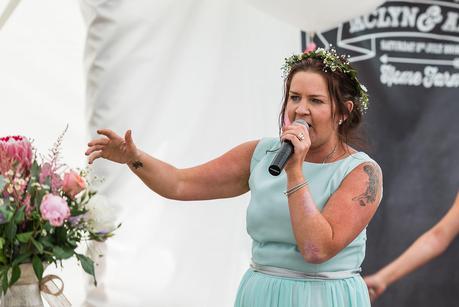 Rustic Wedding with Adam + Jaclyn brides sister rapping at a wedding