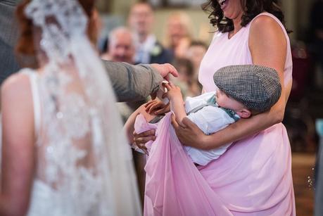 Rustic Wedding with Adam + Jaclyn groom being passed his wedding ring