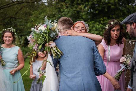 Rustic Wedding with Adam + Jaclyn a bride being congratulated outside hillmorton church
