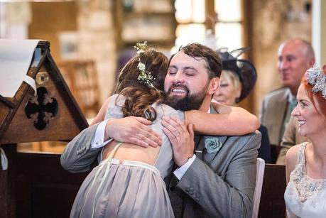 Rustic Wedding with Adam + Jaclyn groom hugging a flower girl