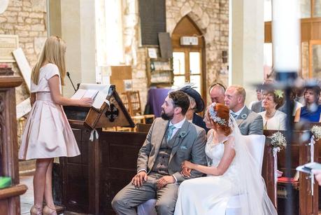 Rustic Wedding with Adam + Jaclyn the happy couple listening to a reading