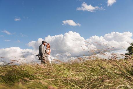 Rustic Wedding with Adam + Jaclyn bride and groom posing in a field