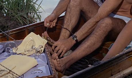 From Russia With Love – Bond’s Gingham Shirt and Swim Trunks A reliable Rolex lets Bond keep track of the time his champagne is in the water to get appropriate chill.
