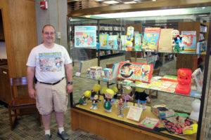 Pop Culture League first challenge: shelfie Harvey Mercheum items on display at the Schenectady County Public Library, back case.
