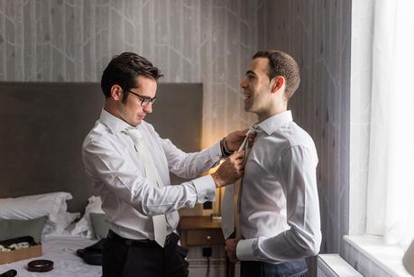 Wood Norton Hotel | Enric & Joules an usher adjusting the grooms tie