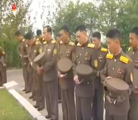 Officers of the South P'yo'ngan People's Security Bureau pay their respects at a P'yo'ngso'ng cemetery on September 15, 2016 (Photo: Korean Central Television).