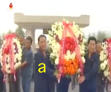South P'yo'ngan WPK Provincial Committee Chairman Pak T'ae Song [a] and provincial officials deliver floral wreaths to a cemetery in the provincial capital of P'yo'ngso'ng on September 15, 2016 (Photo: Korean Central Television).