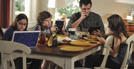 Image result for people sitting at a restaurant table, all on their cell phones