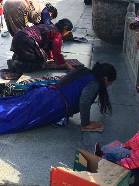 The Roof of the World: Why Travelling to Tibet Should Be On Your Bucket list! prostrating-in-tibet