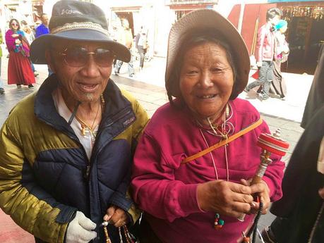 The Roof of the World: Why Travelling to Tibet Should Be On Your Bucket list! tibetan-couple-in-the-streets-of-lasa