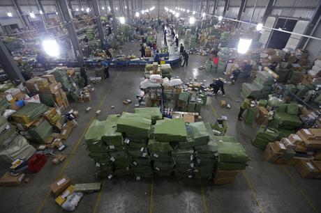 The Wonder of Shopping on Taobao: China’s Secret Weapon. A general view shows employees sorting packages along a conveyor belt at a hub of ZTO Express Delivery company in Wuhan