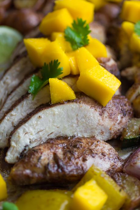 This Jamaican Chicken Sheet Pan Dinner is topped with fresh mango, cooks on one pan, and is ready in 30 minutes!