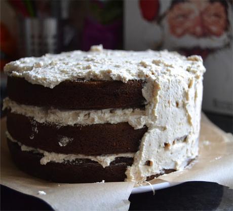 Dark gingerbread cake with cream cheese frosting incorporating crushed ginger nut biscuits