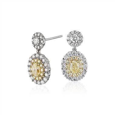 Fancy yellow diamond halo earrings set in 18k white and yellow gold at Blue Nile 