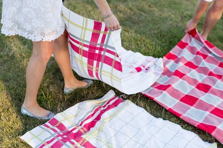 Picnic blankets being spread out for intimate wedding