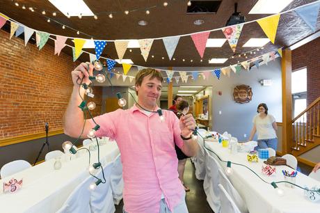 Groom decorates with bunting at destination wedding in Ft. Wayne Indiana