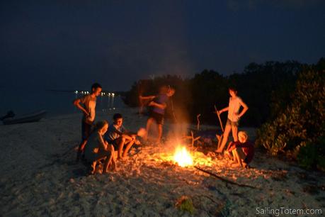 Happy boat kids, happy boat The teen bonfire, carefully spaced away from their parents