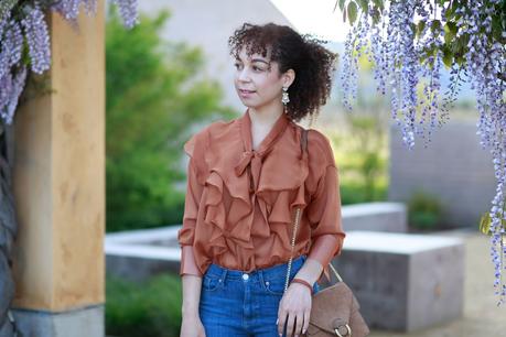 girl with natural curls wearing ruffle blouse top