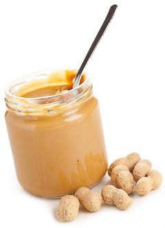 Is Peanut Butter Good or Bad for Your Health? Nutrition Facts peanut butter tub with spoon