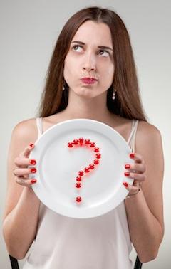 woman holding vitamin question plate