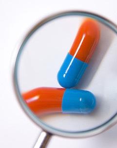 vitamin capsules under magnifying glass