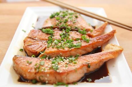 cooked salmon on plate with chopsticks