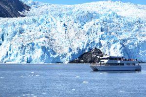 A tour boat passes Aialik glacier.
