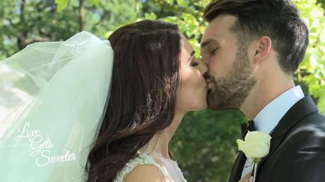 An Elegant and Stylish Lakes Wedding Video bride and groom sharing a kiss under the try out of the summer sun