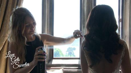 An Elegant and Stylish Lakes Wedding Video wedding hair stylist perfecting the brides hair after she's dressed and before the wedding ceremony